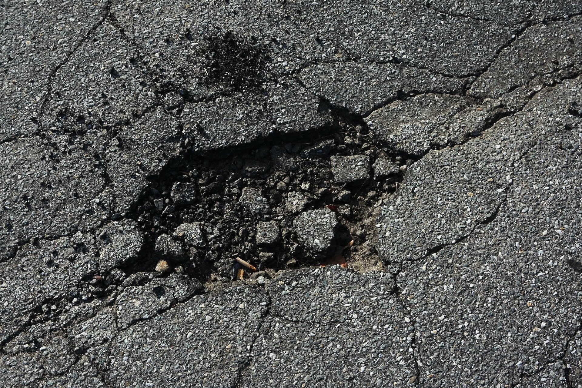 Pothole damage in asphalt pavement.